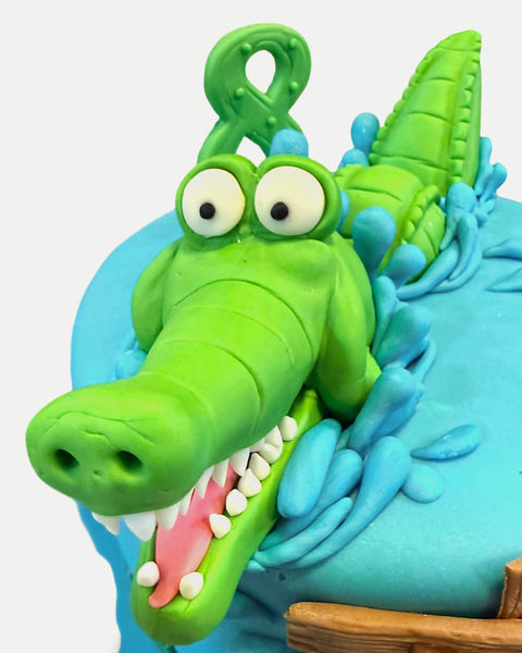 Detalle de la cabeza del cocodrilo de fondant con dientes y salpicaduras L'Autrichienne CDMX